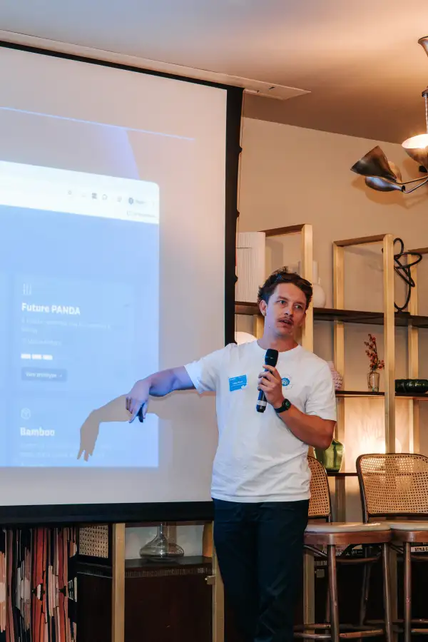 A speaker demonstrating a holiday-planning prototype on the presentation screen