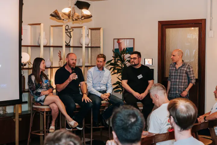 Five panellists discussing AI in front of attendees at the first loveAI gathering